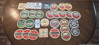 All 29 Dutch beer coasters laid out on table showing fronts and brand variety
