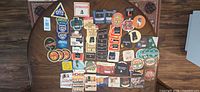Full lot overview of assorted Irish beer coasters spread on table