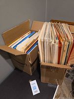 Two cardboard boxes filled with assorted file folders