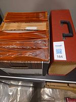 Woodgrain pattern file box and red briefcase-style expanding file side by side