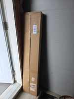 sealed cardboard shipping box containing firewood rack