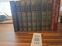 Front view of all nine books showing spine titles and numbering