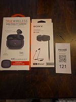 Front of both sealed headphone boxes with MaxSold tag