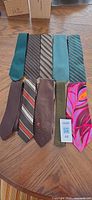 All nine ties laid out showing colours and patterns