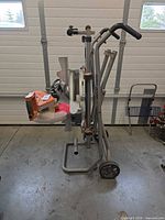 Side view of Ridgid miter saw on folded rolling stand