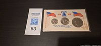 Front view of sealed three-coin Bicentennial set with display card
