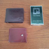 Group shot of Paco Rabanne after shave box and two wallets