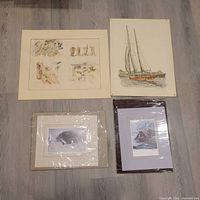 Group shot of all four unframed signed prints