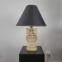 Full view of lamp showing shade and carved base
