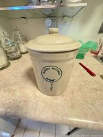 Front view showing stamp, lid on