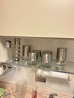 Full set of jars, grinder and pour bottle on shelf