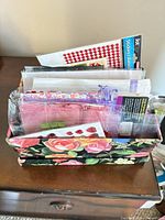 floral box with assorted stickers, cards, bags visible