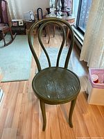 Front view of olive green bentwood chair showing curved back and round seat