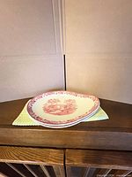 Pair of stacked Tonquin oval platters on cabinet