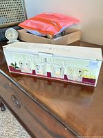 Front view of retail box displaying four faceted square crystal votive holders