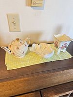 Overview of teapot, leaf dish and planter on tabletop