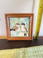 Front view of framed porcelain tile showing sparrows and signature