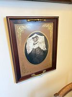 Full view of framed portrait on wall