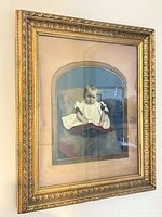 Full view angled of framed infant photograph on wall
