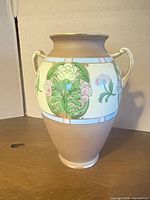 Front view showing floral panel and two handles