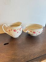 Creamer and sugar bowl together on tabletop