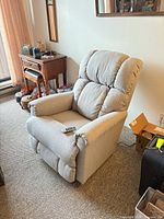 Front angled view of La-Z-Boy power recliner chair, remote resting on arm