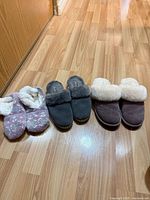 All three pairs of slippers lined up on floor