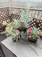 Balcony view showing four of the six artificial potted plants in various decorative pots