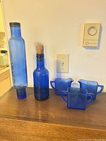 Front view of all five cobalt blue glass pieces