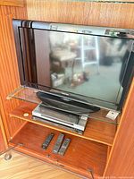 Overall view of Toshiba TV on shelf with components