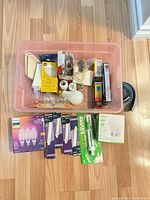 Overall view of pink bin with mixed bulbs, sockets, adapters and trim pieces