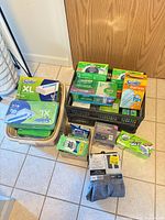 Group shot of all packaged cleaning supplies, curtains and weights