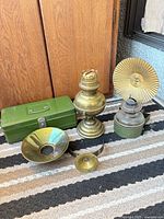 All items in lot: brass oil lamp, green steel lamp with brass reflector, brass bowl reflector, brass ring, green metal box