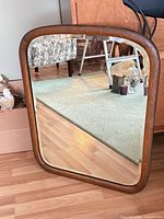 Front view of mirror leaning against furniture