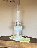 Full view of milk glass hurricane lamp with chimney and cord