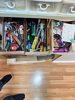 Drawer view showing entire assortment of hand tools, suction cups, bungee cords