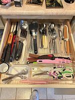 Drawer view showing full assortment of flatware and utensils