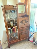 Full view of oak secretary/display cabinet showing glass door, drop-front desk, mirror and drawers