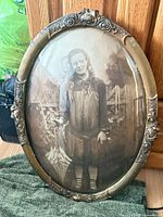 Front view of oval framed sepia photograph