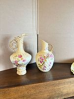 Both porcelain ewers on shelf