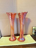 Front view of both matching iridescent marigold trumpet vases