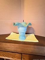 Full view of vase on table showing overall form and color