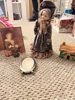 Group shot of doll, frame, trinket box, art card, brooch