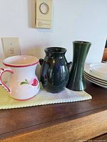 Three vases and stack of plates