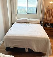 Full view of bed showing mattress and foundation