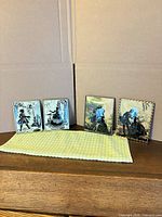 all four plaques standing on surface showing fronts