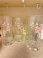 Front view of several tumblers showing floral decals and bases