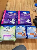 All five sealed TENA packs displayed