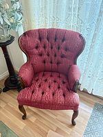 Front view of dusty-rose tufted wingback chair