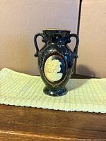 Front view showing cameo medallion and handles